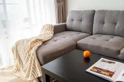a living room with a couch and a table at Cozy NEW brand 1BR at JVC Binghatti Corner in Dubai