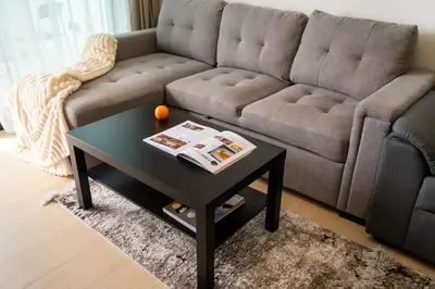 a living room with a couch and a coffee table at Cozy NEW brand 1BR at JVC Binghatti Corner in Dubai