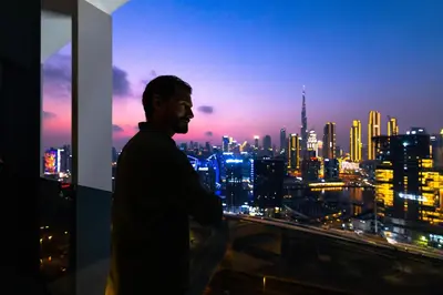 a man standing on top of a building with a city skyline at THE UPSIDE Downtown Dubai in Dubai