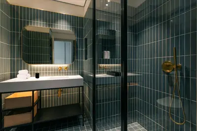 a bathroom with two sinks and a glass shower at THE UPSIDE Downtown Dubai in Dubai