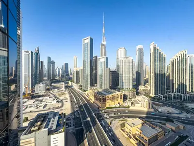 a view of a city skyline with skyscrapers at Infinity Rooftop Pool with Full Burj Khalifa View in Dubai