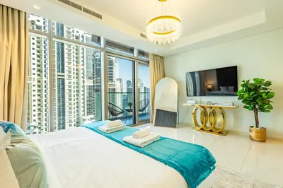 a bedroom with a large bed and a large window at Infinity Rooftop Pool with Full Burj Khalifa View in Dubai