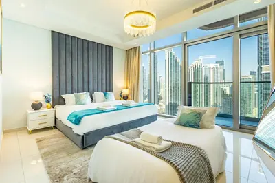 a bedroom with two beds and a large window at Infinity Rooftop Pool with Full Burj Khalifa View in Dubai