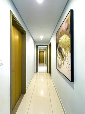 a corridor in a building with a painting on the wall at Infinity Rooftop Pool with Full Burj Khalifa View in Dubai