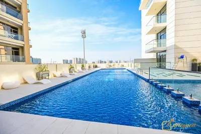 a swimming pool on the roof of a building at New Studio 5min Walk to Bus Stop in Dubai