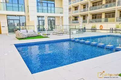 a swimming pool in the middle of a building at New Studio 5min Walk to Bus Stop in Dubai