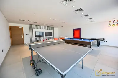 a room with a ping pong table and a ping pong ball at New Studio 5min Walk to Bus Stop in Dubai
