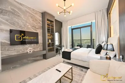 a bedroom with a king sized bed and a large window at New Studio 5min Walk to Bus Stop in Dubai