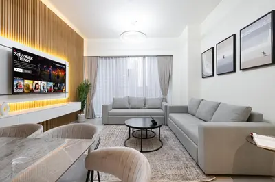 a living room with a couch and a table at Grande Signature by Emaar! Amazing Pool, Gym and Location! in Dubai