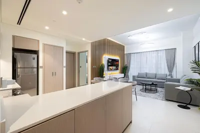 an open kitchen and living room with a couch at Grande Signature by Emaar! Amazing Pool, Gym and Location! in Dubai