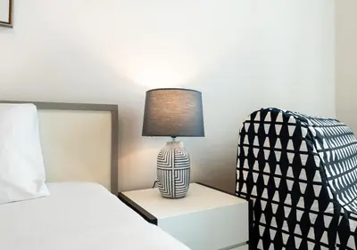 a lamp sitting on a night stand next to a bed at Cozy 1BR The Address JBR in Dubai