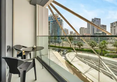 a balcony with a table and chairs and a view of the city at Cozy 1BR The Address JBR in Dubai