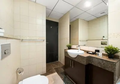 a bathroom with a sink and a mirror at Bay Central Modern Studio in Dubai