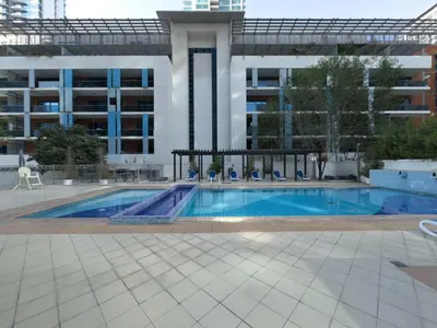 a swimming pool in front of a building at Luxe Vista - Top Location Dubai Marina 1BR - Metro and Beach Access in Dubai
