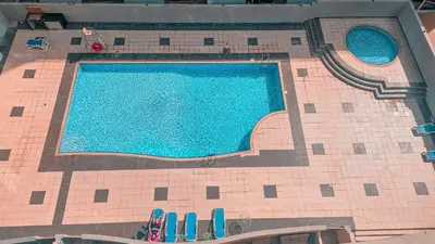 an overhead view of a swimming pool in a building at Upgraded Studio In Dubai Marina in Dubai