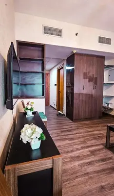 a living room with a table with flowers on it at Upgraded Studio In Dubai Marina in Dubai