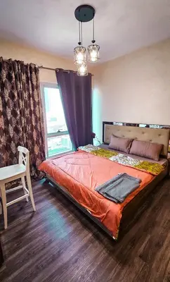 a bedroom with a large bed and a window at Upgraded Studio In Dubai Marina in Dubai