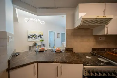 a kitchen with a counter top and a stove at Homes & Beyond l 2BR in the Heart of Dubai Marina in Dubai
