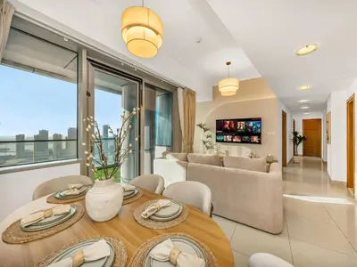 a living room with a table and a couch at Sensational direct Sea, AIN View and Palm Jumeirah in Dubai Marina in Dubai
