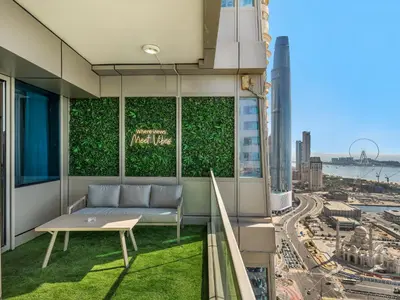 a living room with a couch and a view of a city at Sensational direct Sea, AIN View and Palm Jumeirah in Dubai Marina in Dubai