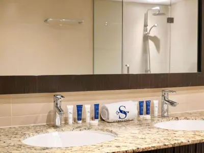 a bathroom counter with two sinks and a mirror at Oceanfront 2BR Apartment with Perfect Views in Dubai