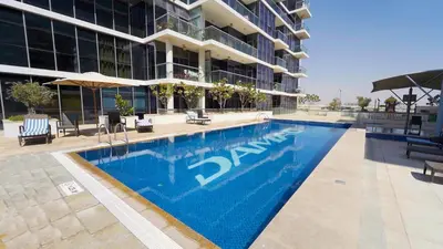 a swimming pool in front of a building at AWS Holiday Homes - Charming stay near Golf Course in Dubai