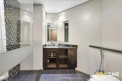 a bathroom with a sink and a mirror at Cayan Escape Lavish 1BR with Sea View in Dubai