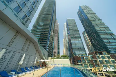 a pool in the middle of a city with tall buildings at Cayan Escape Lavish 1BR with Sea View in Dubai