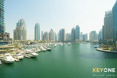 a group of boats in a river in a city at Cayan Escape Lavish 1BR with Sea View in Dubai