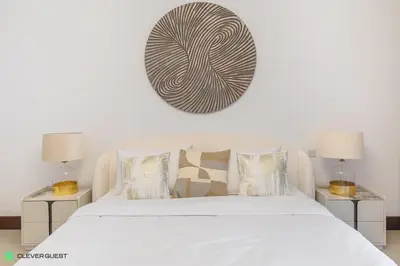 a bedroom with a white bed with two lamps at Clever Guest 030 Golden Mile 6 in Dubai