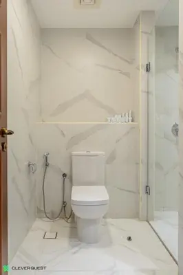 a white bathroom with a toilet and a shower at Clever Guest 030 Golden Mile 6 in Dubai