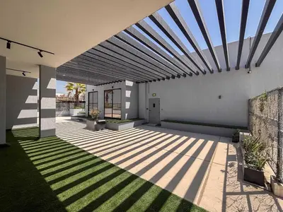 a patio with a sun shining on the side of a house at Frank Porter - MYKA Residence in Dubai