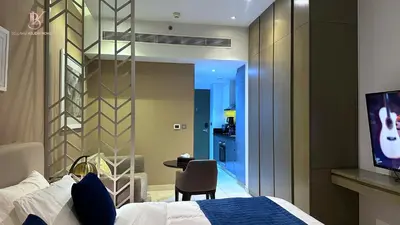 a bedroom with a bed and a tv in a room at Bellaviu Holiday Homes Peaceful Escape at DAMAC Maison Prive in Dubai