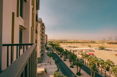 a view from the balcony of a building with palm trees at Voyage Studio In Mag City in Dubai
