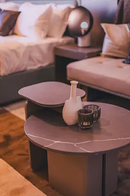 a table with a vase and two candles on it at Voyage Studio In Mag City in Dubai