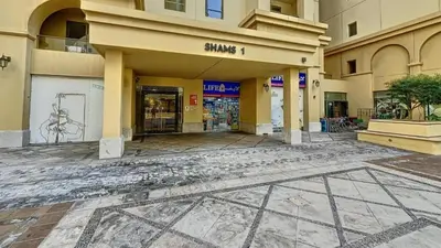 an empty street in a building with a store at Devine Homes JBR Hostel in Dubai