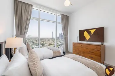 a bedroom with three beds and a large window at Vogue JLT Banyan Tree Residences Hillside, near Marina and JBR, Two Bedroom Apartment with Balcony and City View, Access to all Amenities in Dubai