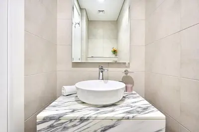 a bathroom with a sink on a marble counter at Aykon City 2BR Luxury Stay Close to Downtown in Dubai