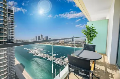 a balcony with a table and a view of the water at LUX The Marina Vista Beachfront Suite 5 in Dubai