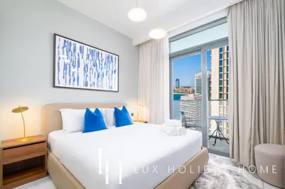a bedroom with a bed and a large window at LUX The Marina Vista Beachfront Suite 5 in Dubai
