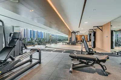a gym with cardio equipment in a building at Luxury Studio with Jacuzzi & Canal Views in Dubai