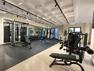 a gym with several treadmills and exercise machines at Vogue Madinat Jumeirah Living Jadeel near Burj AlArab, One-Bedroom Apartment with Large Balcony and Pool View, Access to All Amenities in Dubai