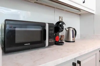 a microwave sitting on a counter in a kitchen at Elite Villa in Dubai in Dubai