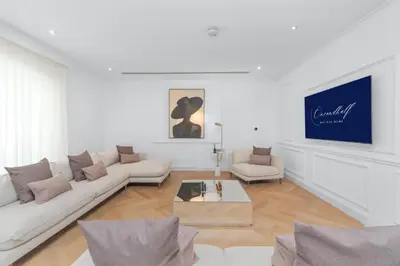a white living room with a couch and a table at Elite Villa in Dubai in Dubai