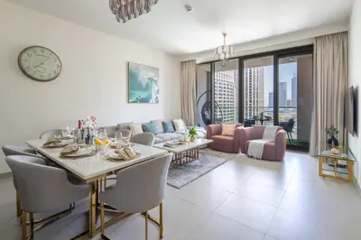 a living room with a table and a dining room at Frank Porter - Forte Tower 1 in Dubai