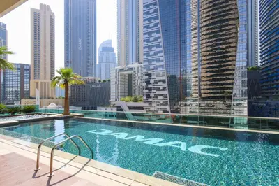 a swimming pool with a view of a city at studio in downtown Damac upper crest next to dubai mall in Dubai