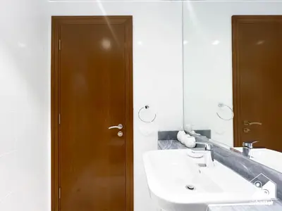 a bathroom with a sink and a mirror at Business Bay 2BR in Amna Tower & Canal Views in Dubai