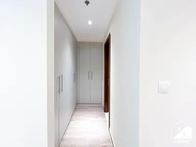 an empty corridor with white walls and a hallway with white ceilings at Business Bay 2BR in Amna Tower & Canal Views in Dubai