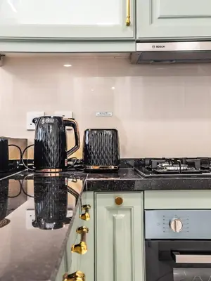 a tea kettle sitting on top of a kitchen counter at Arjan 1BR Near Miracle Garden Pool & Parking in Dubai