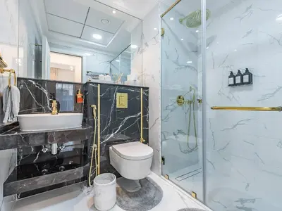 a bathroom with a shower and a toilet and a sink at Arjan 1BR Near Miracle Garden Pool & Parking in Dubai